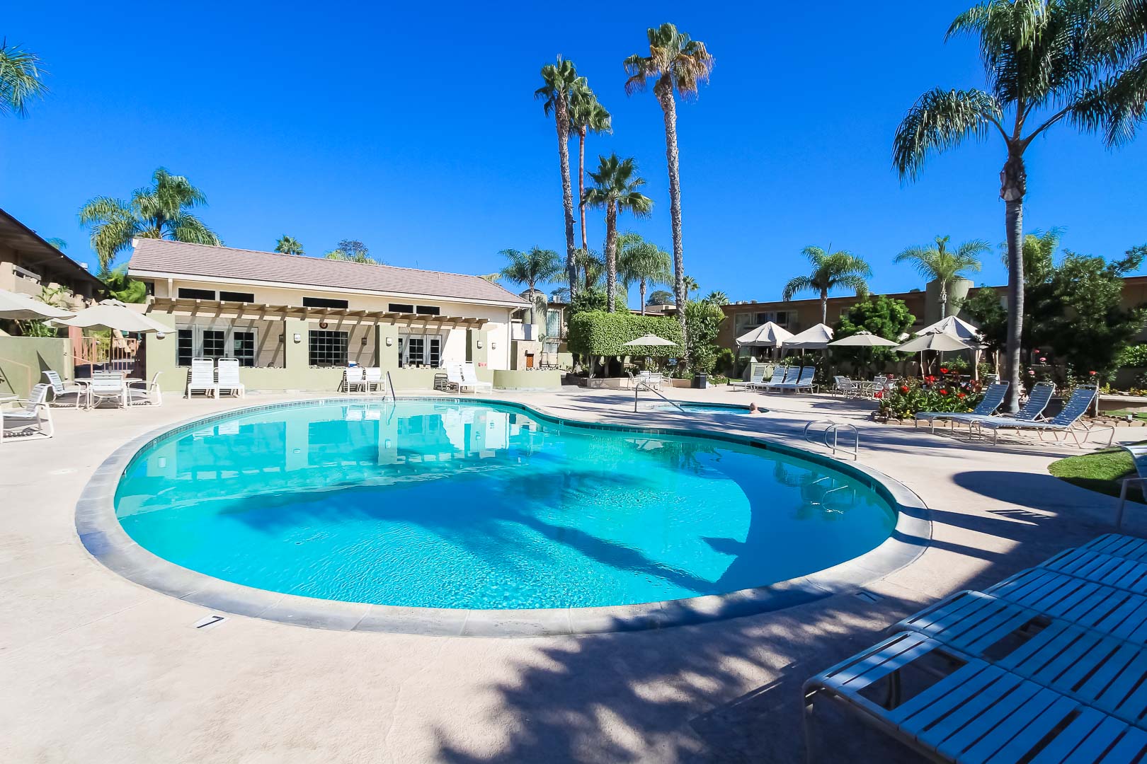 Clear skies and a clean outdoor swimming pool at VRI's Winner Circle Resort in California.
